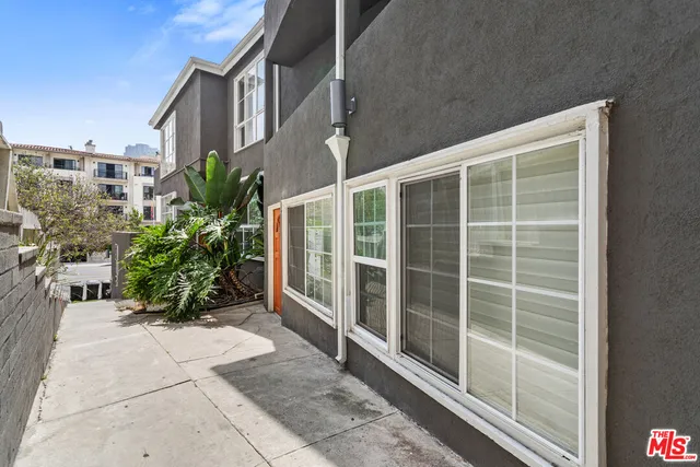 a view of front door with potted plants