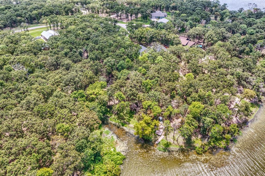 Lot 68 Anchor Point Quinlan, TX 75474 - Photo 6 of 15 a view of a house with a lush green forest