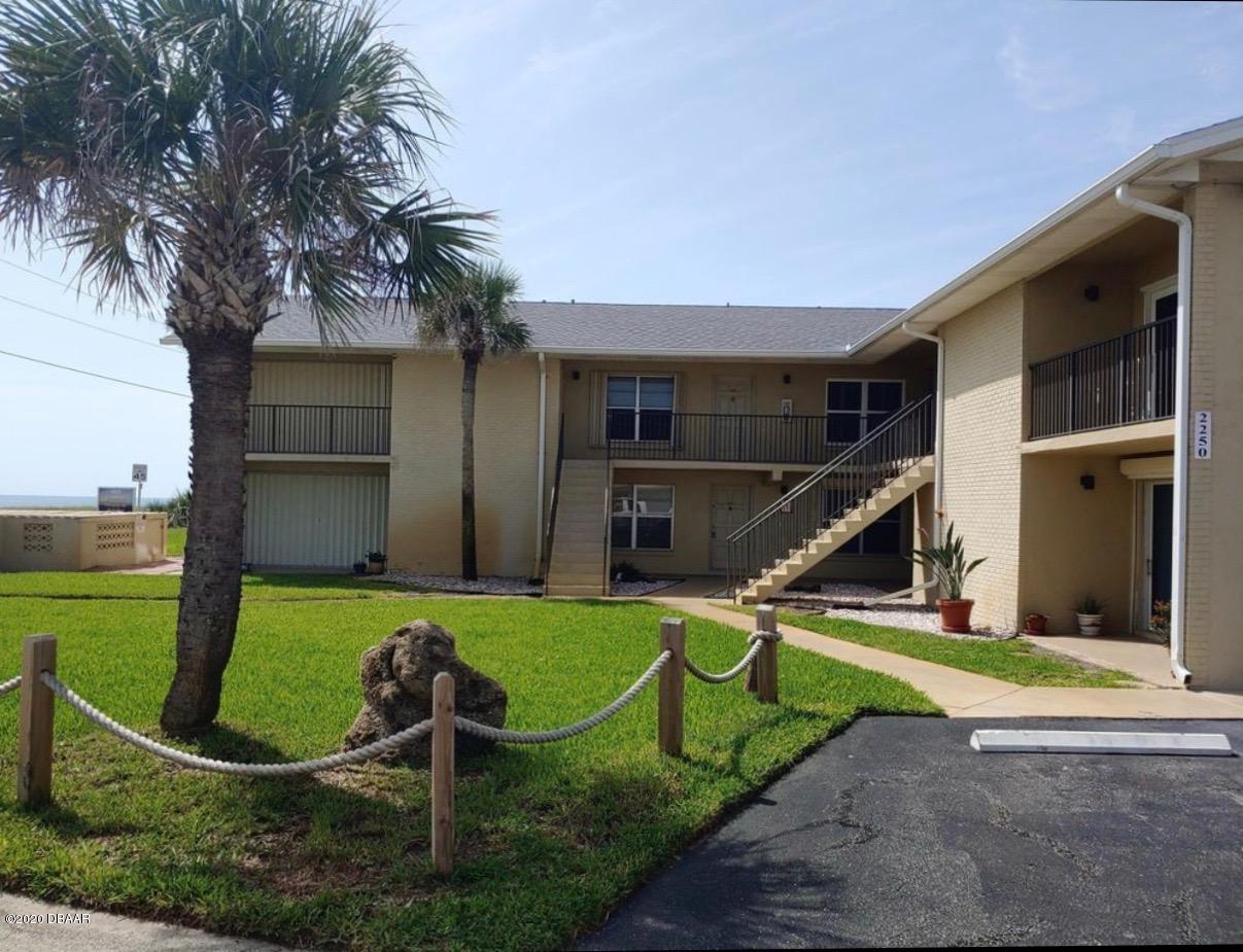 a view of a chair and table in backyard