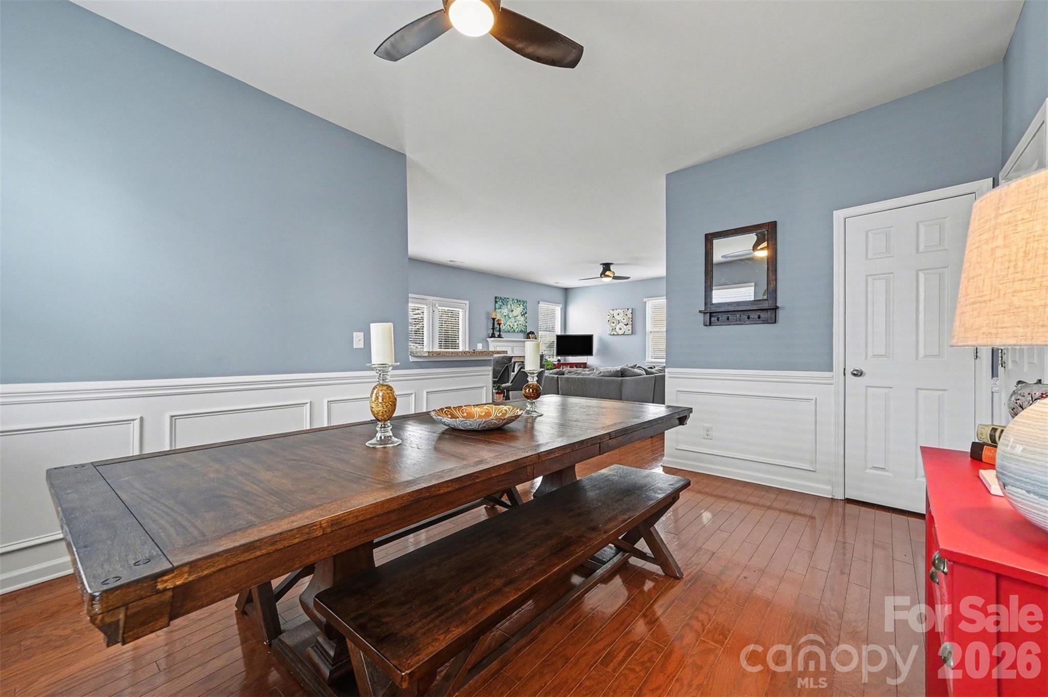 3009 Canopy Drive Indian Trail, NC 28079 - Photo 11 of 35 a dining room with wooden floor and a chandelier