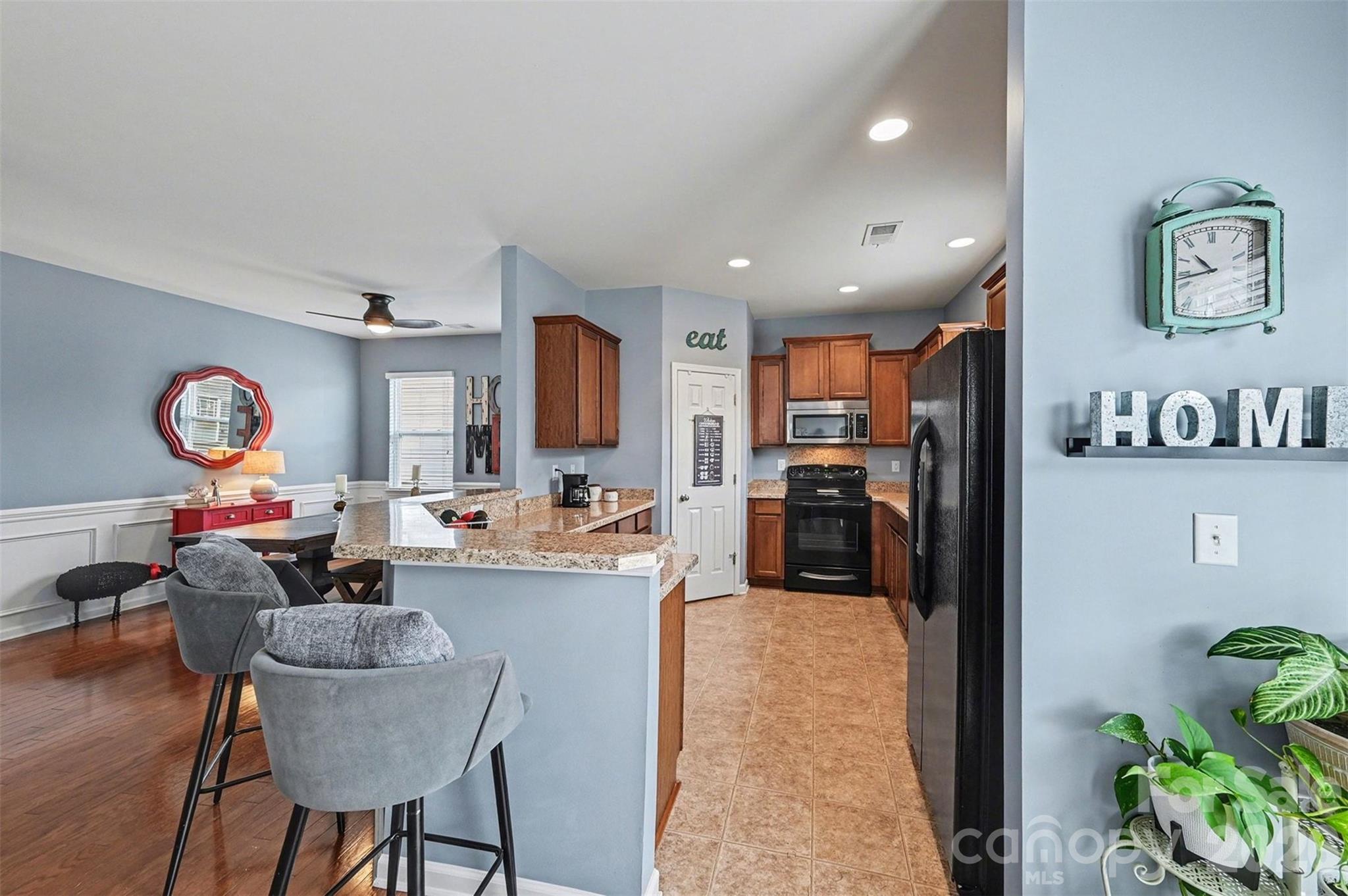 3009 Canopy Drive Indian Trail, NC 28079 - Photo 12 of 35 a living room with furniture a large window and stainless steel appliances