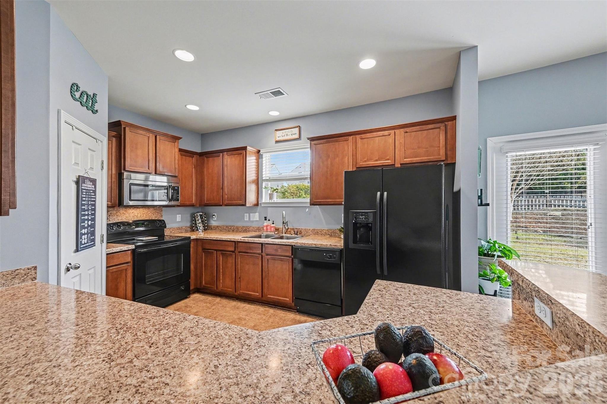 3009 Canopy Drive Indian Trail, NC 28079 - Photo 13 of 35 a kitchen with granite countertop a refrigerator stove top oven and sink