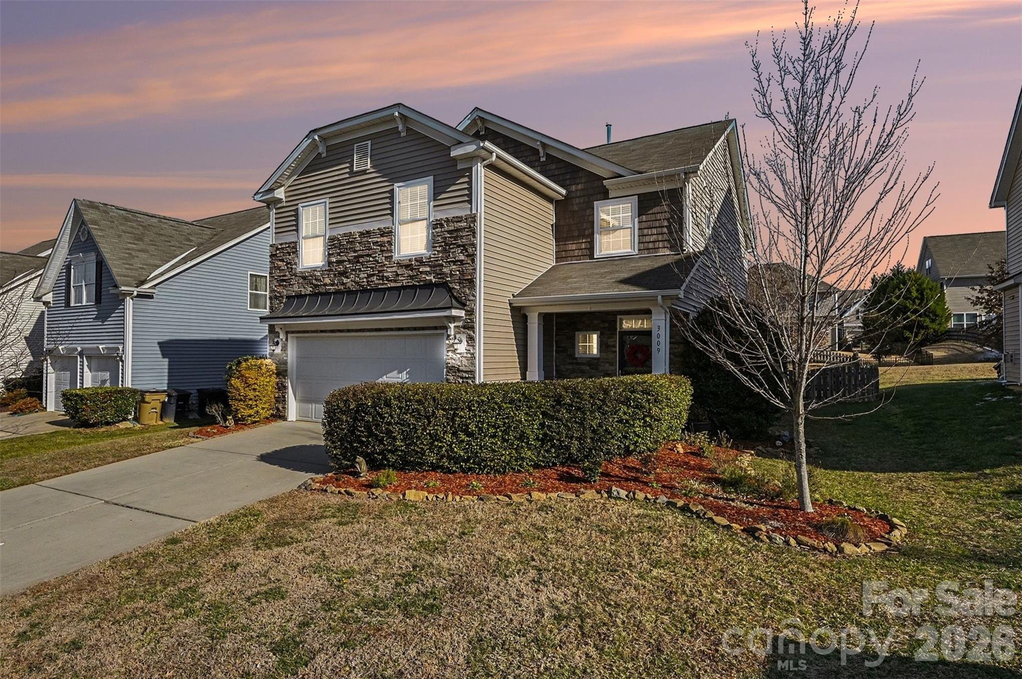 3009 Canopy Drive Indian Trail, NC 28079 - Photo 2 of 35 a front view of a house with a yard