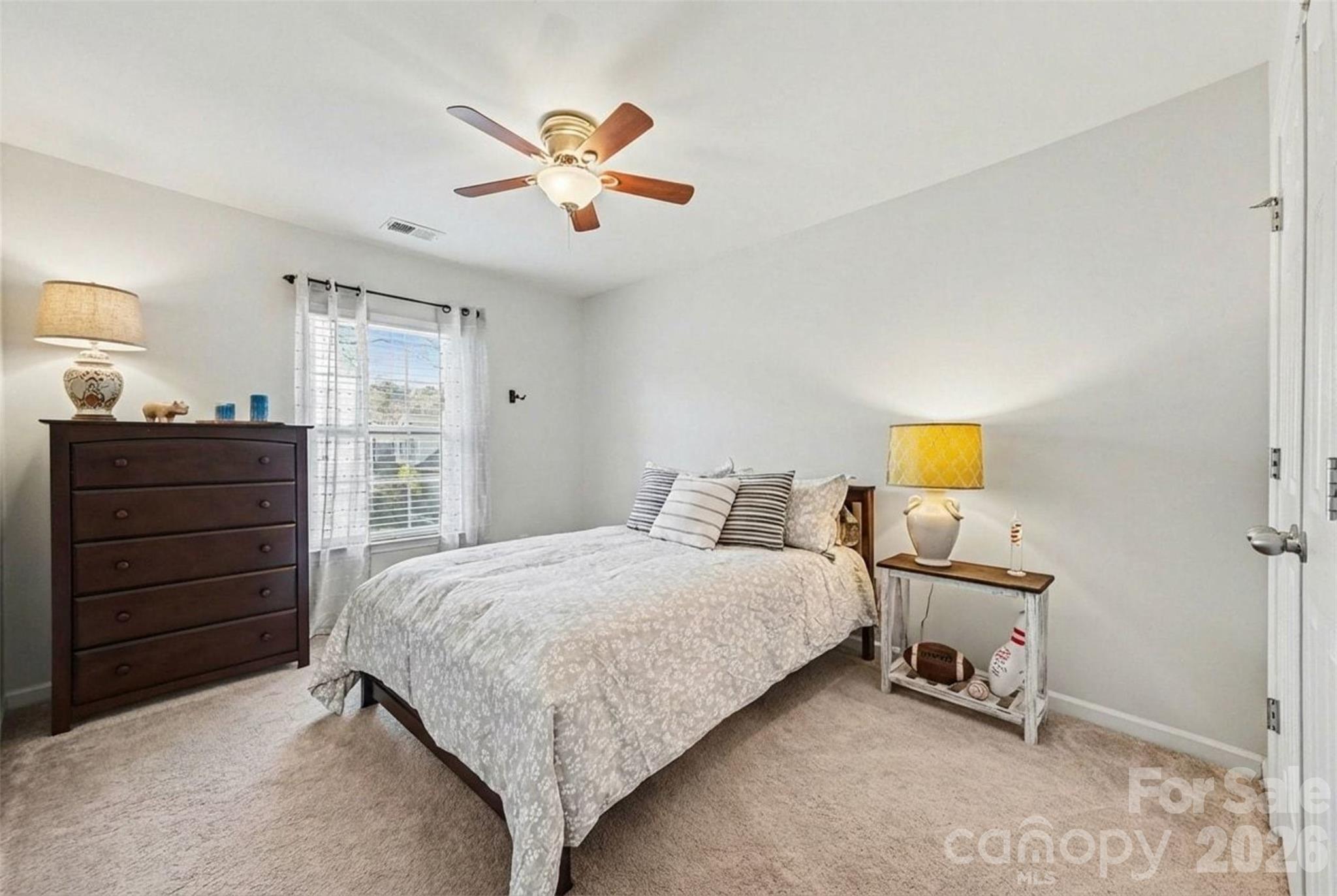 3009 Canopy Drive Indian Trail, NC 28079 - Photo 24 of 35 a bedroom with a bed and a chandelier