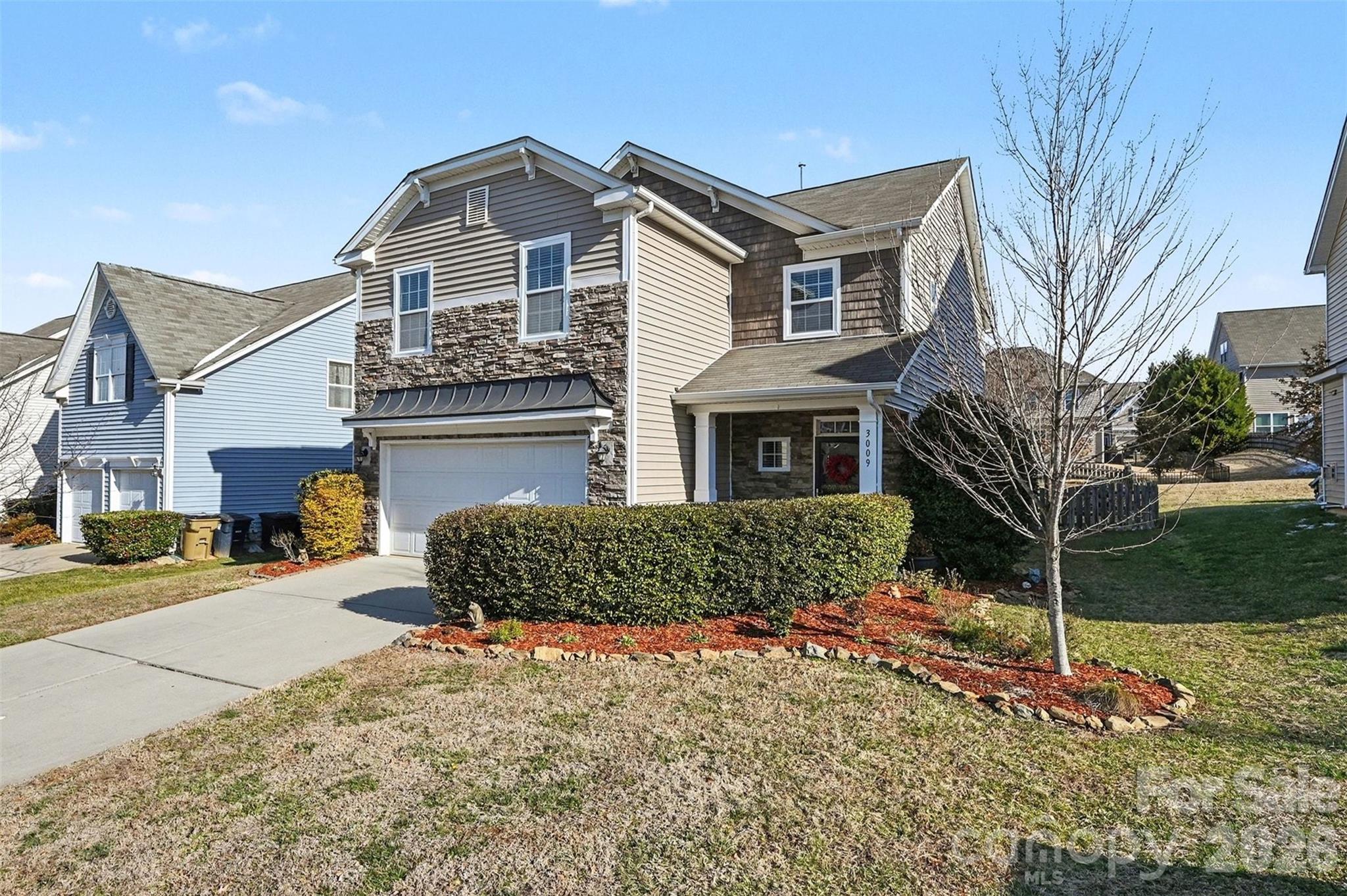 3009 Canopy Drive Indian Trail, NC 28079 - Photo 5 of 35 a front view of a house with a yard