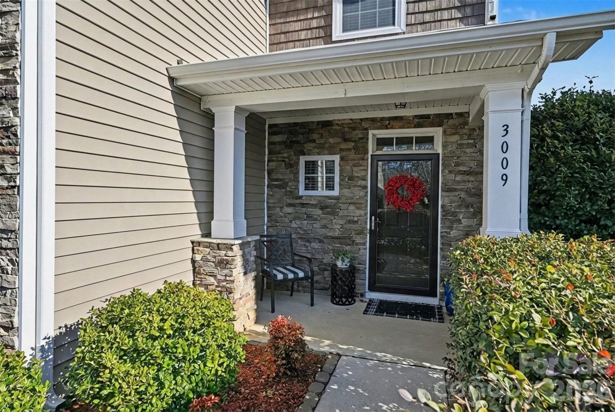 3009 Canopy Drive Indian Trail, NC 28079 - Photo 6 of 35 a front view of a house with a garden