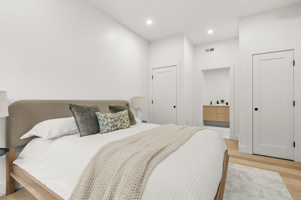 47 Condor Street, Unit 203A Boston, MA 02128 - Photo 7 of 15 a bedroom with a bed and a night lamp