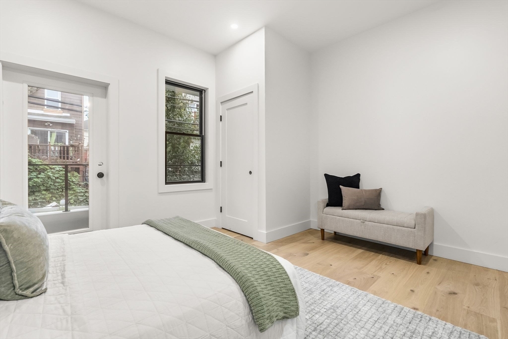 47 Condor Street, Unit 203A Boston, MA 02128 - Photo 10 of 15 a bedroom with a bed and a couch