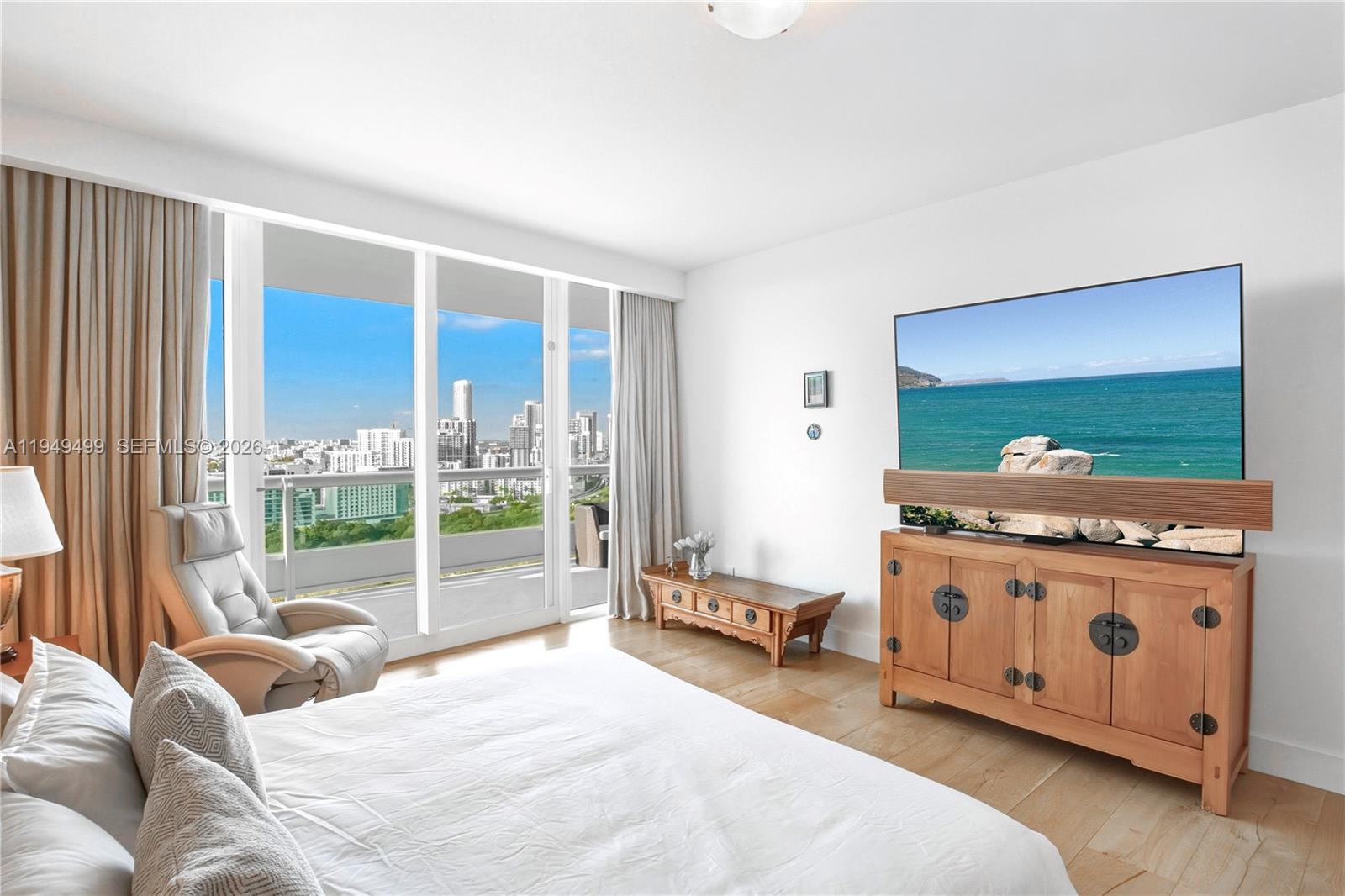 1643 Brickell Avenue, Unit 2506 Miami, FL 33129 - Photo 17 of 85 a bed room with a bed television and a large window