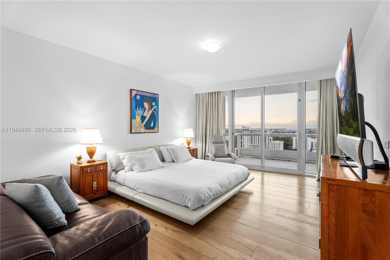 1643 Brickell Avenue, Unit 2506 Miami, FL 33129 - Photo 18 of 85 a bedroom with a large bed and a couch