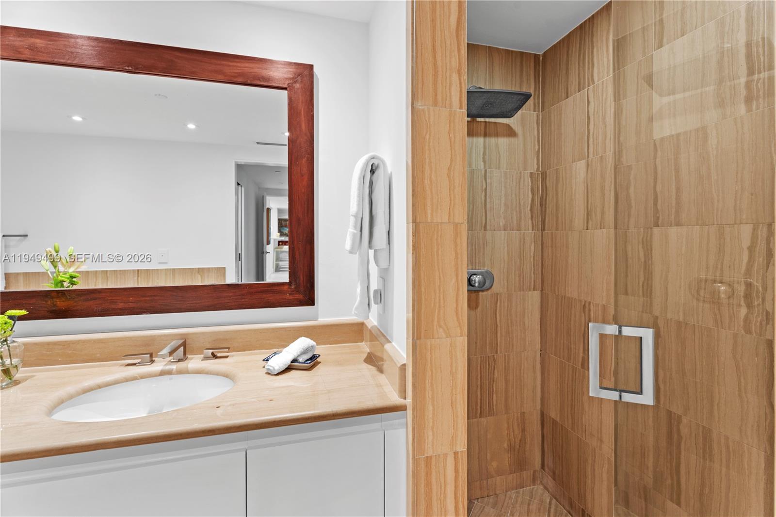 1643 Brickell Avenue, Unit 2506 Miami, FL 33129 - Photo 21 of 85 a bathroom with a granite countertop sink and a mirror
