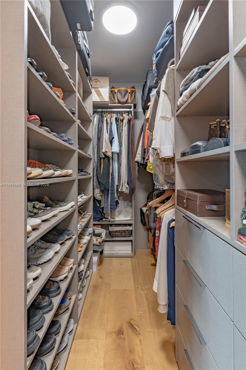 1643 Brickell Avenue, Unit 2506 Miami, FL 33129 - Photo 22 of 85 a view of walk in closet with clothes and shoes