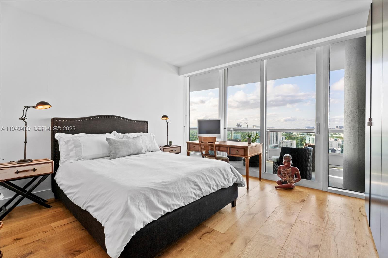 1643 Brickell Avenue, Unit 2506 Miami, FL 33129 - Photo 24 of 85 a bedroom with a bed and a large window