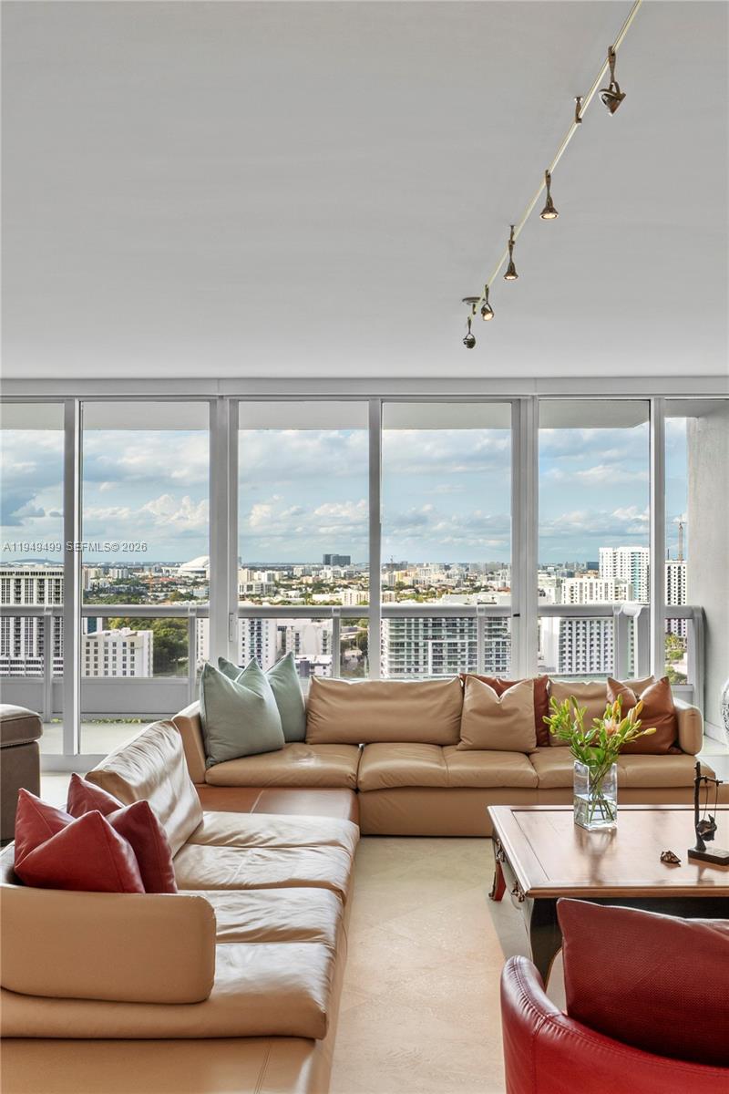 1643 Brickell Avenue, Unit 2506 Miami, FL 33129 - Photo 28 of 85 a living room with furniture and a large window