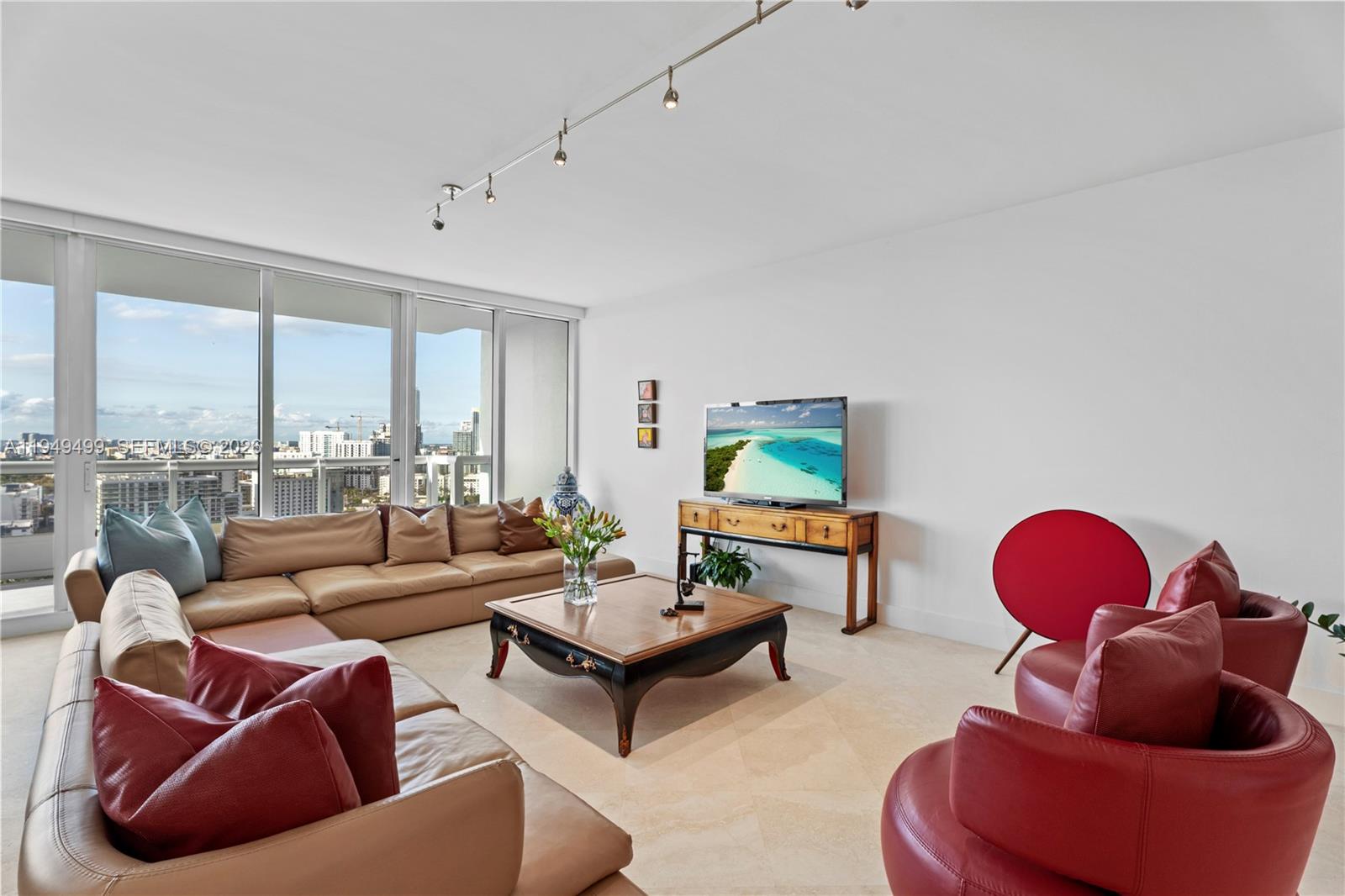1643 Brickell Avenue, Unit 2506 Miami, FL 33129 - Photo 29 of 85 a living room with furniture a rug and a floor to ceiling window