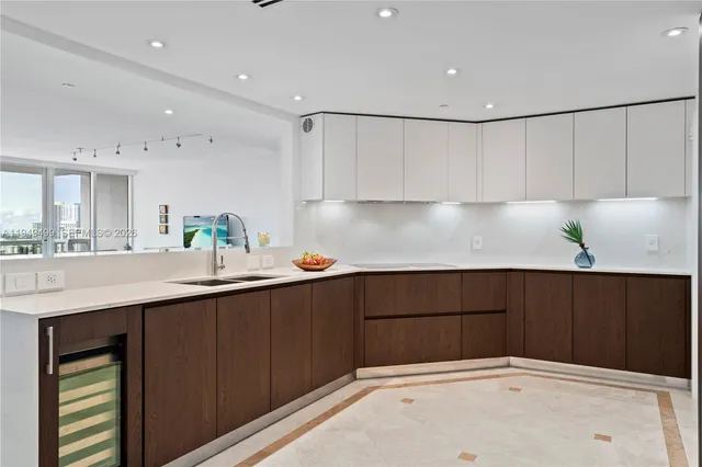 a living room with furniture kitchen view and a window