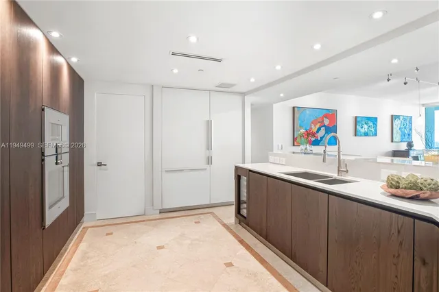 a bed room with a bed television and a large window