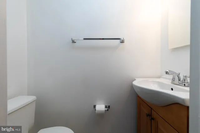 a bathroom with a sink a toilet and mirror