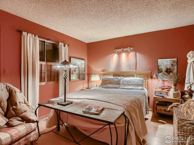 a bedroom with a bed and a tv on table