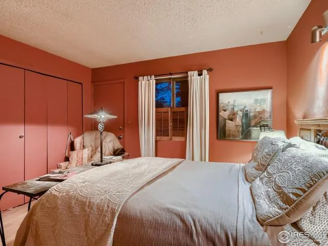 a bedroom with a large bed and a window