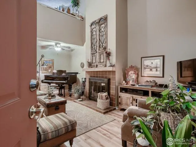 a living room with furniture a fireplace and a flat screen tv