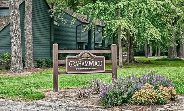 a view of a street sign under a large tree