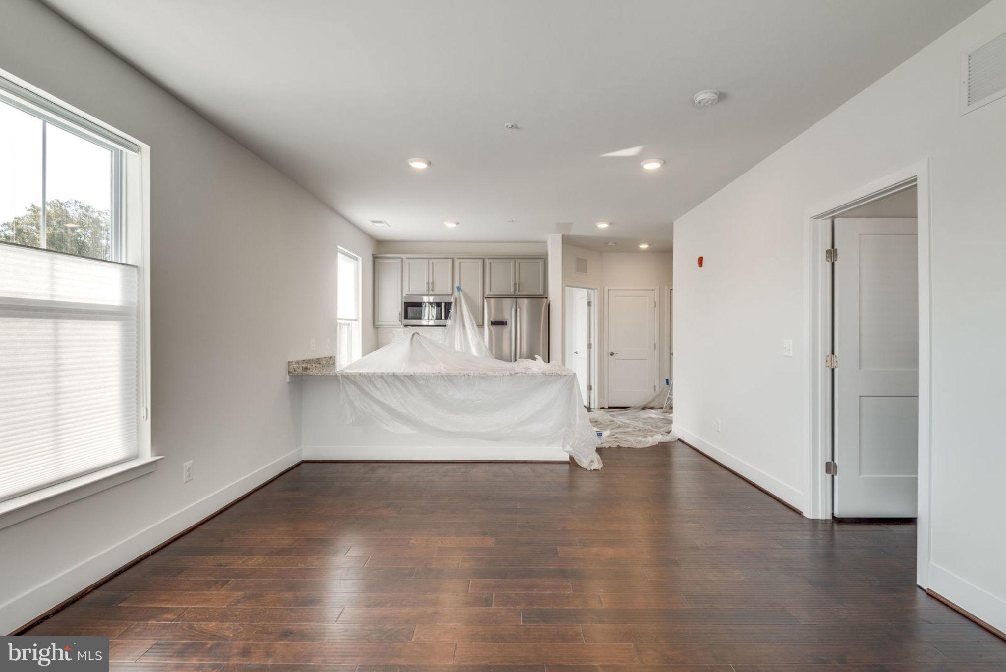 1951 Reston Valley Way, Unit 9 Reston, VA 20191 - Photo 7 of 9 LIVING-ROOM WITH KITCHEN VIEW