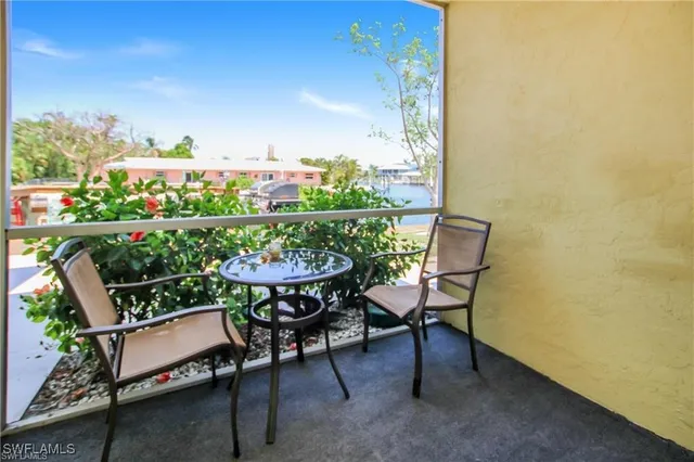 a balcony with table and chairs