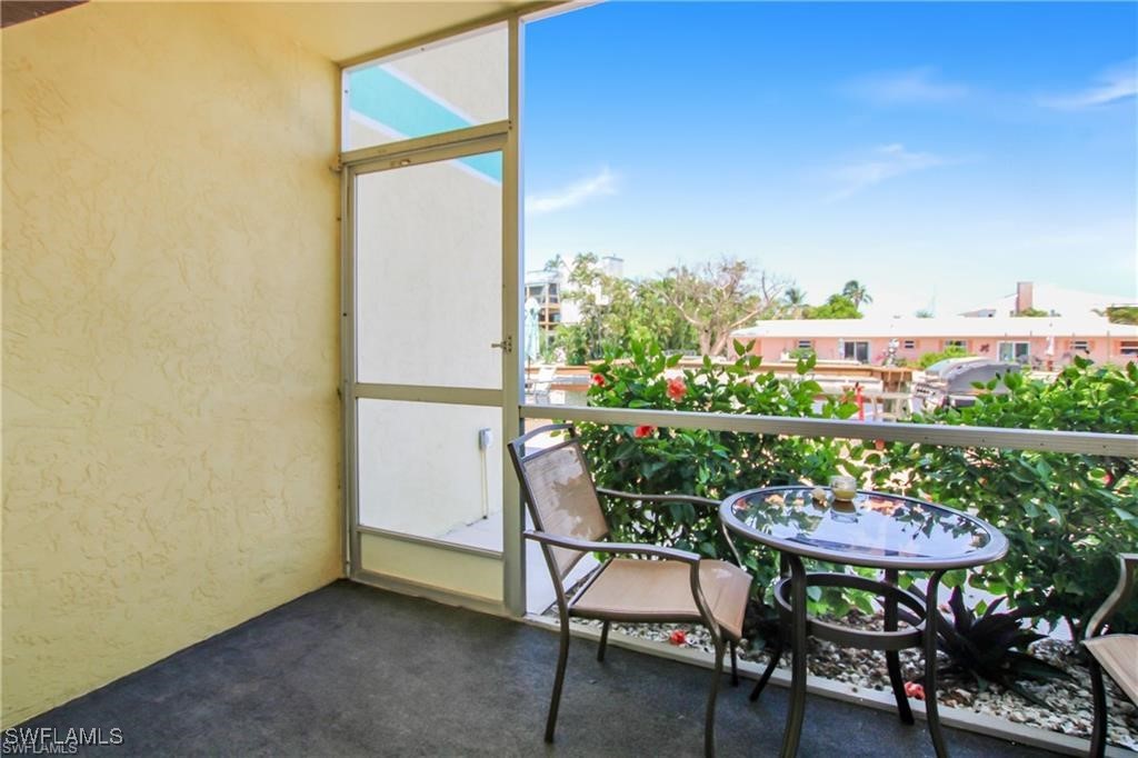 3226 Stringfellow Road St. James City, FL 33956 - Photo 13 of 28 a balcony with table and chairs