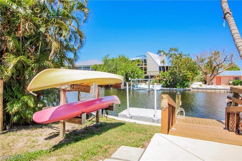 3226 Stringfellow Road St. James City, FL 33956 - Photo 15 of 28 a view of a swimming pool with a table and chairs under an umbrella