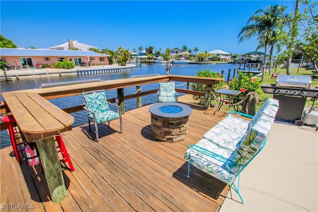 3226 Stringfellow Road St. James City, FL 33956 - Photo 19 of 28 a view of a chairs and table in patio