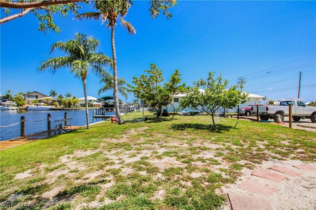 3226 Stringfellow Road St. James City, FL 33956 - Photo 20 of 28 a swimming pool with lawn chairs