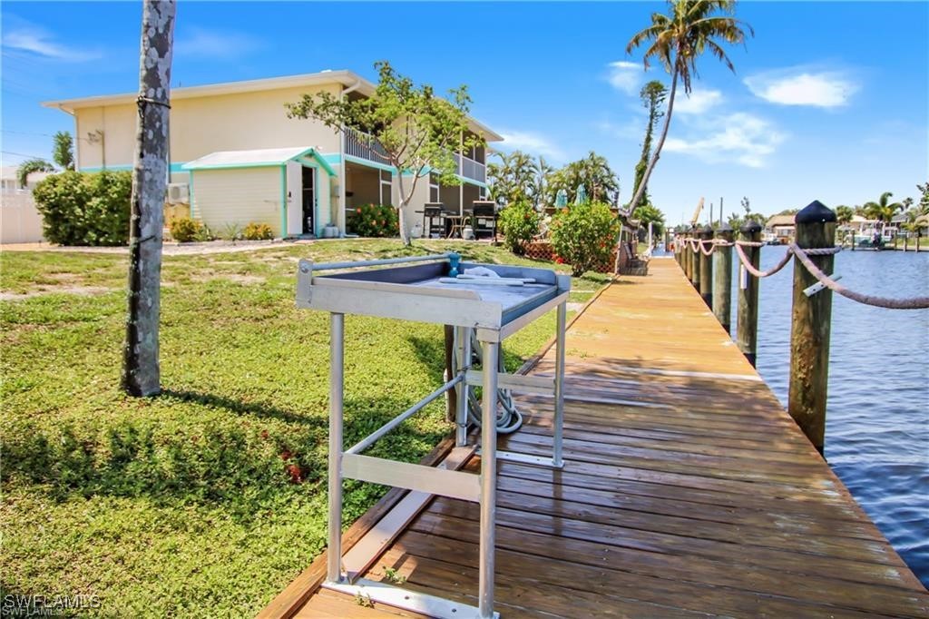 3226 Stringfellow Road St. James City, FL 33956 - Photo 22 of 28 a view of a house with a yard