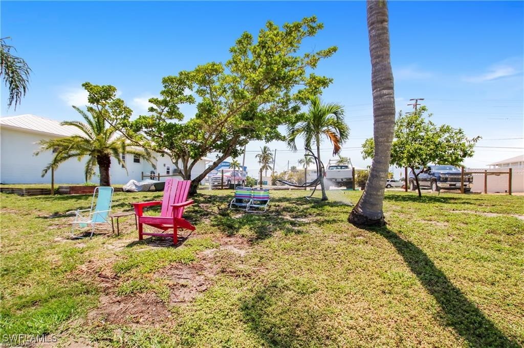 3226 Stringfellow Road St. James City, FL 33956 - Photo 23 of 28 a view of a backyard with swimming pool