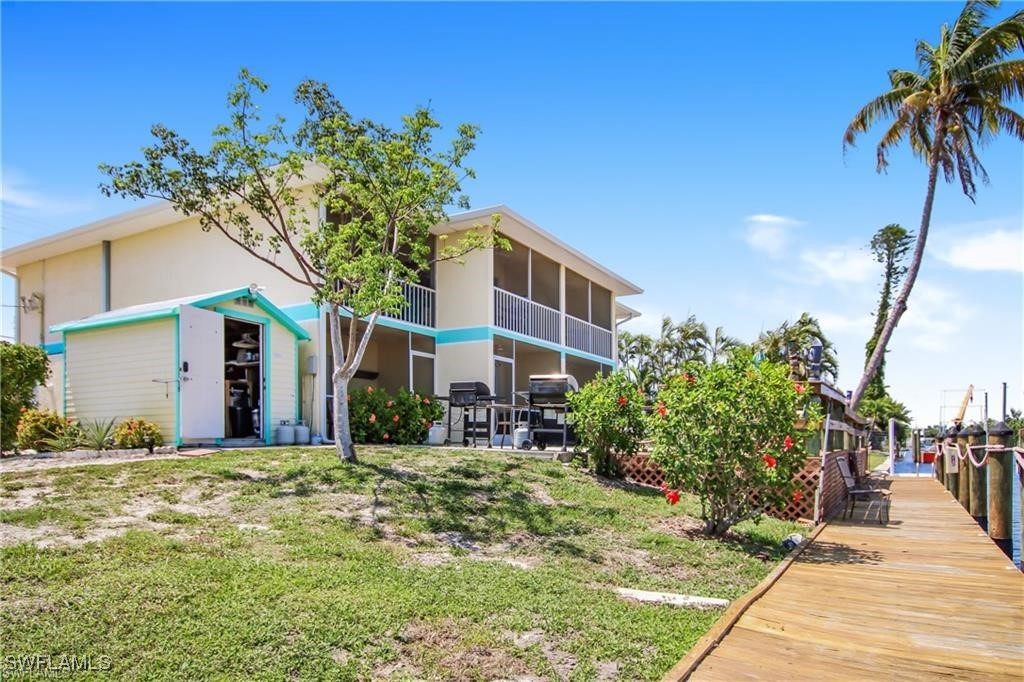 3226 Stringfellow Road St. James City, FL 33956 - Photo 24 of 28 a front view of a house with a yard