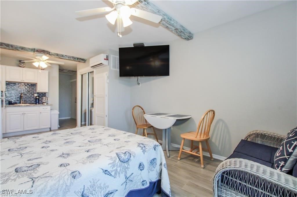 3226 Stringfellow Road St. James City, FL 33956 - Photo 26 of 28 a bedroom with a bed and a flat screen tv