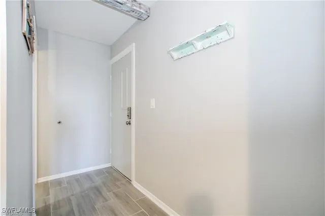 a bedroom with a bed and a refrigerator