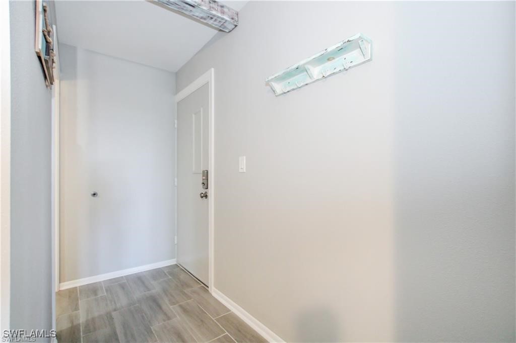 3226 Stringfellow Road St. James City, FL 33956 - Photo 7 of 28 a view of a hallway with wooden floor