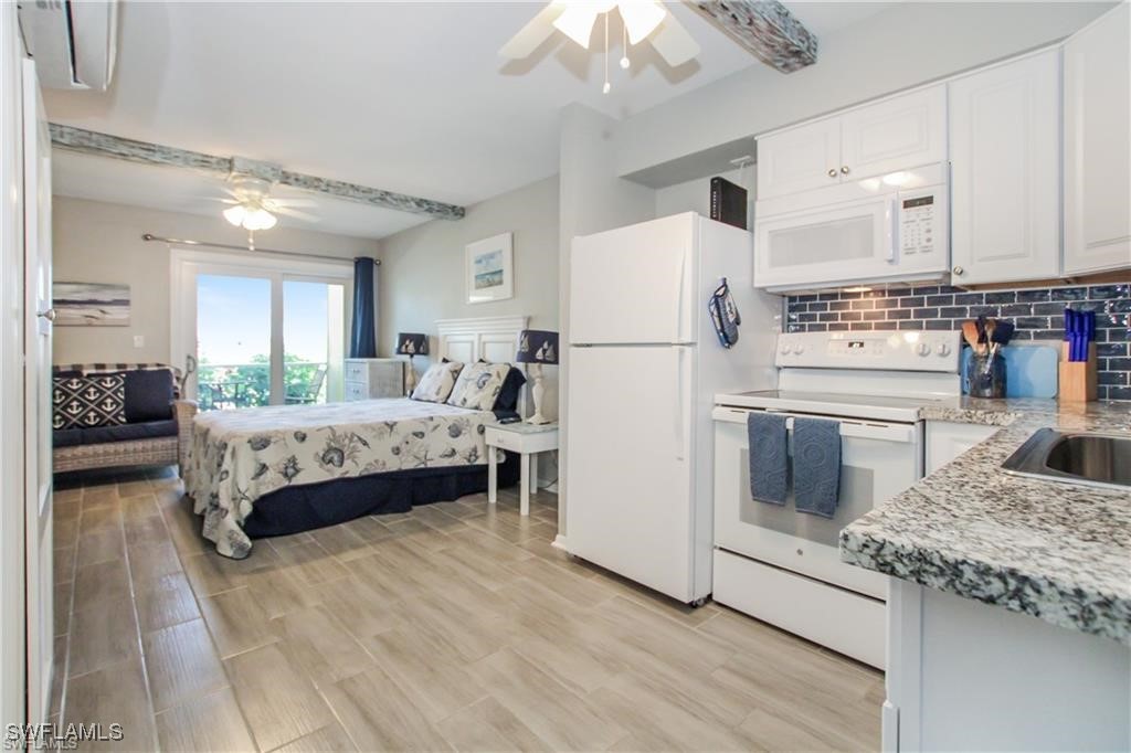 3226 Stringfellow Road St. James City, FL 33956 - Photo 8 of 28 a bedroom with a bed and a refrigerator