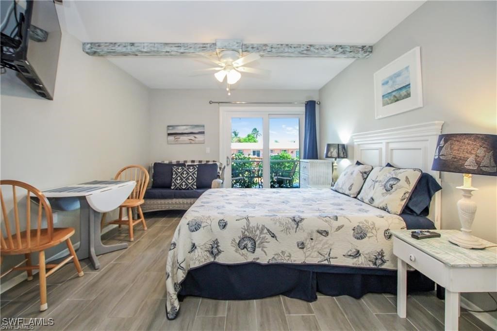 3226 Stringfellow Road St. James City, FL 33956 - Photo 9 of 28 a bedroom with a bed and wooden floor