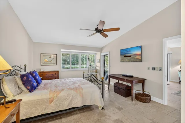 a bedroom with a bed a couch and a window