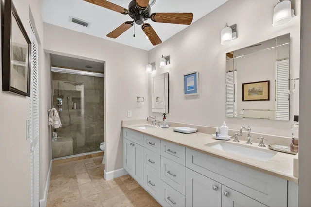 a bathroom with a granite countertop sink mirror and shower
