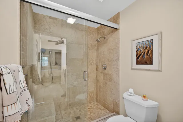 a bathroom with a toilet sink and shower