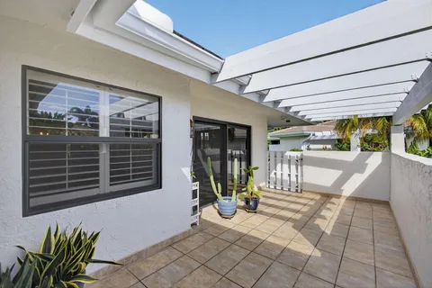 a view of a porch with a table and chairs