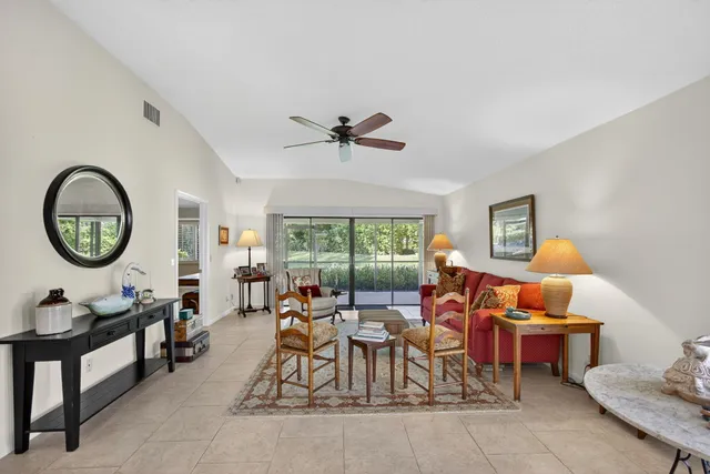 a living room with furniture a window and a clock