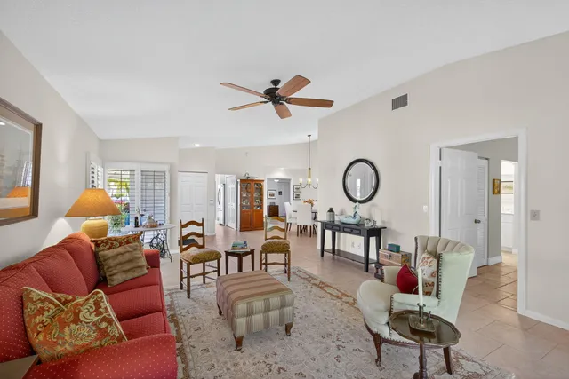 a living room with furniture a rug and a window
