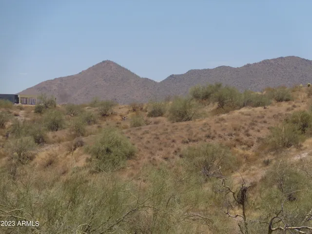 a view of a mountain range with trees in the background