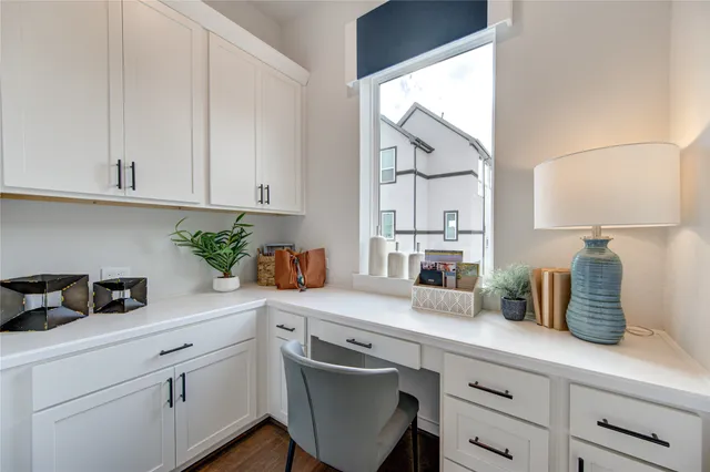 a kitchen with stainless steel appliances white cabinets and a potted plant