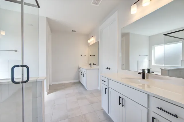 a bathroom with a tub shower and sink