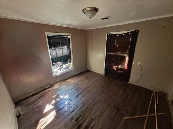 an empty room with wooden floor and closet